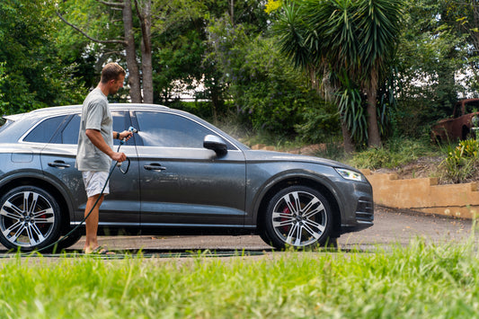 Man washing an Audi SQ5 with Clarity Shampoo. pH neutral wash solution that is safe on all surfaces, high lubricity and suitable for cars, boats, motorcycles, caravans and motoryachts.