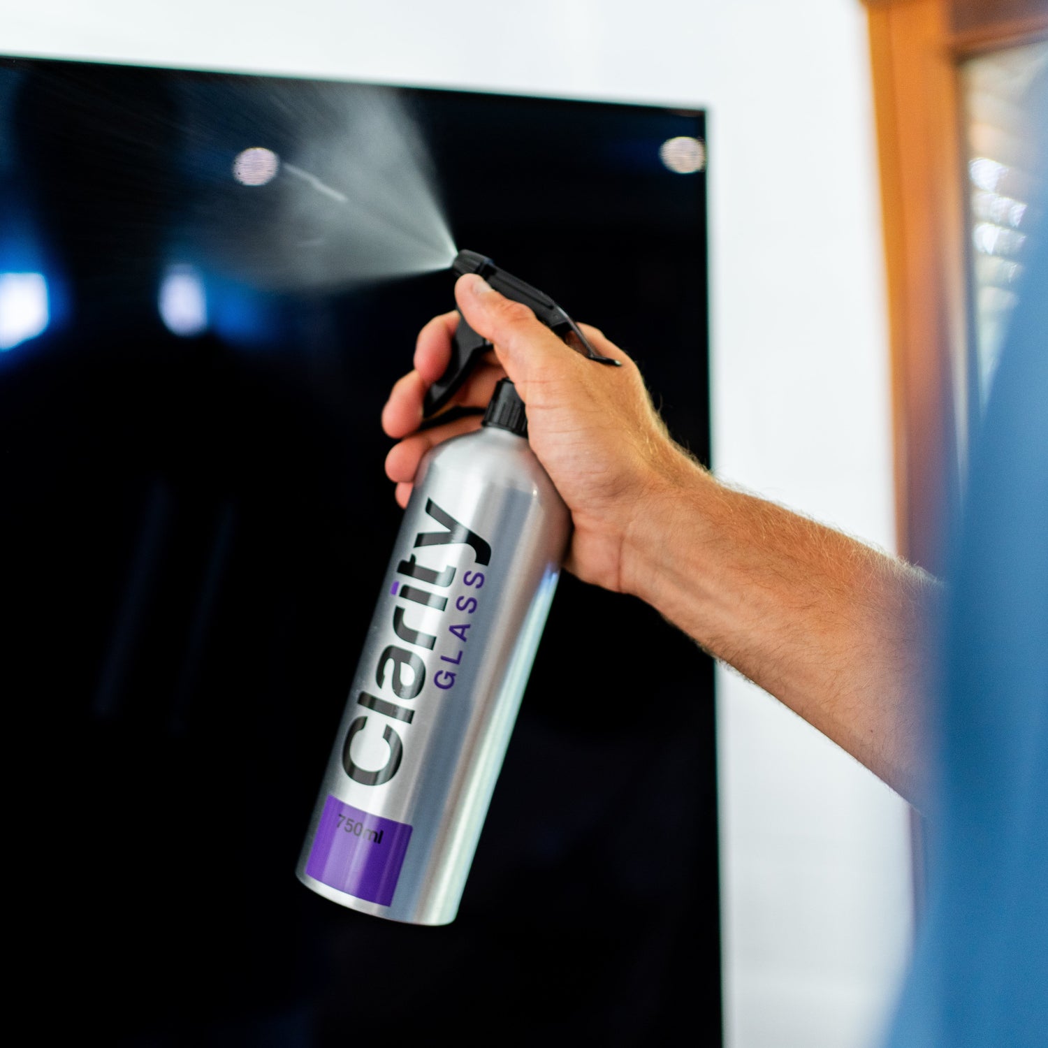 Person using Clarity glass cleaner on a screen
