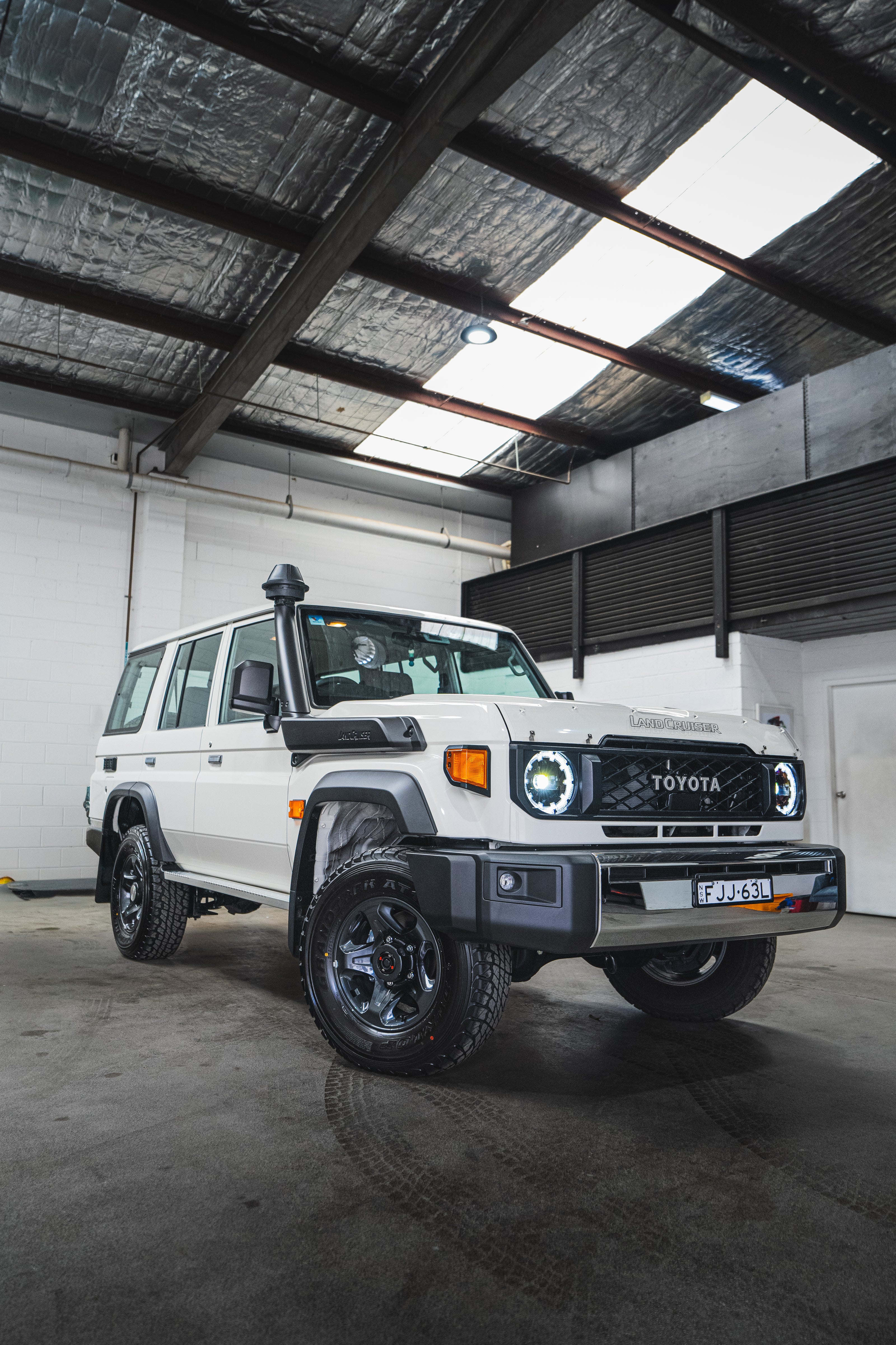 White Toyota inside a warehouse