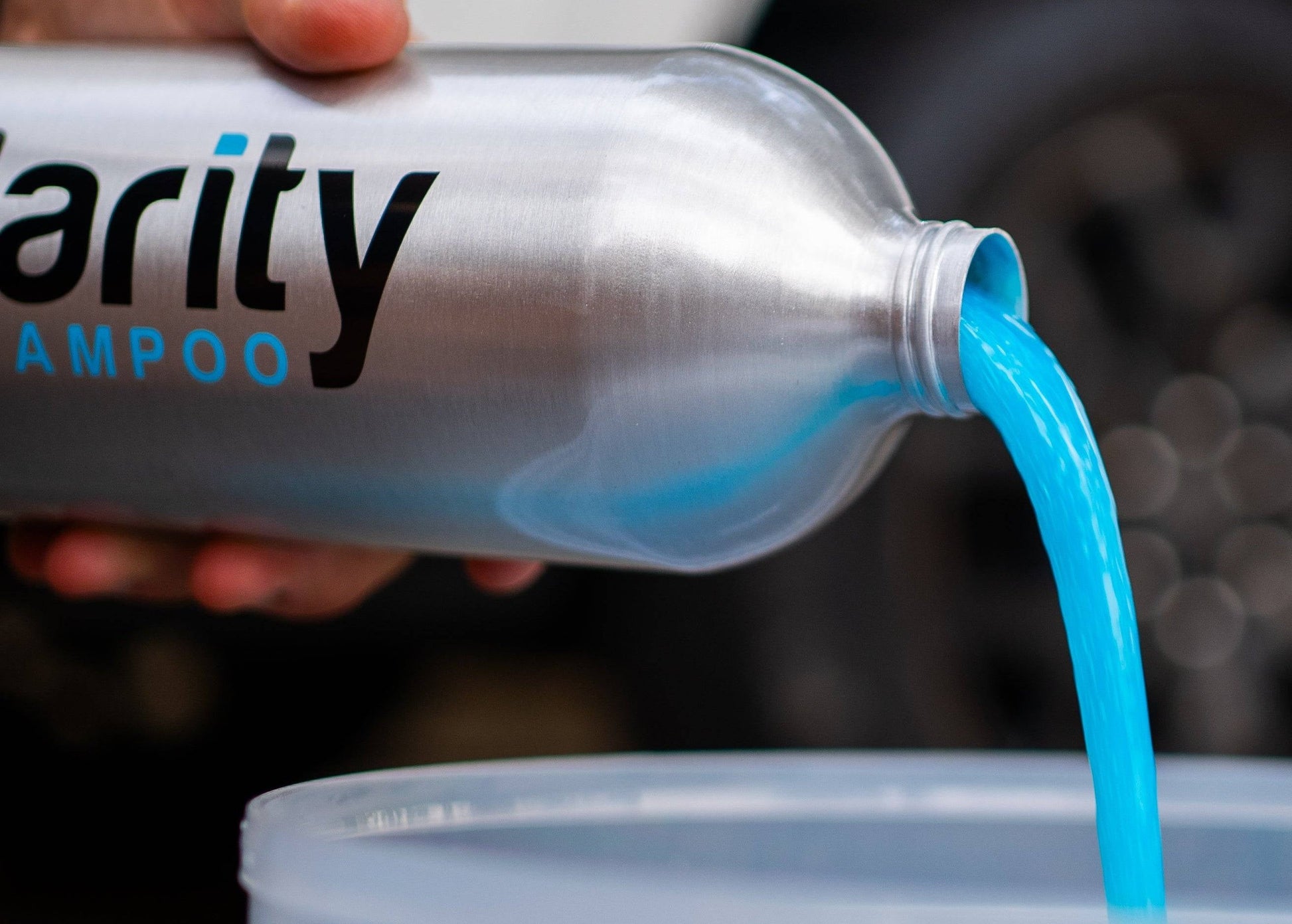 Clarity Car Wash Shampoo being poured into a bucket, preparing for a wash. Showing off it’s fluorescent blue colour.