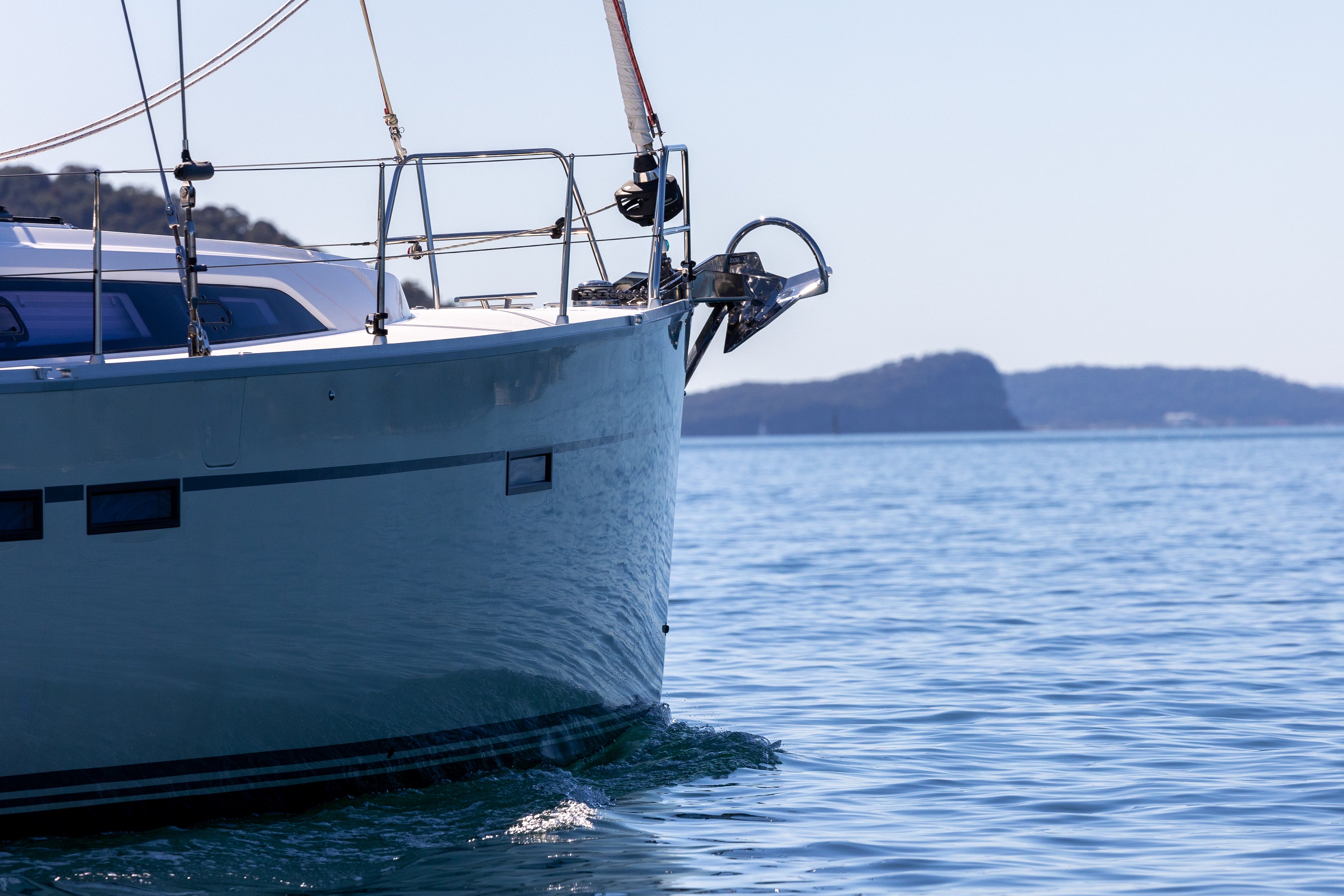 Sailboat on calm water with a clear sky